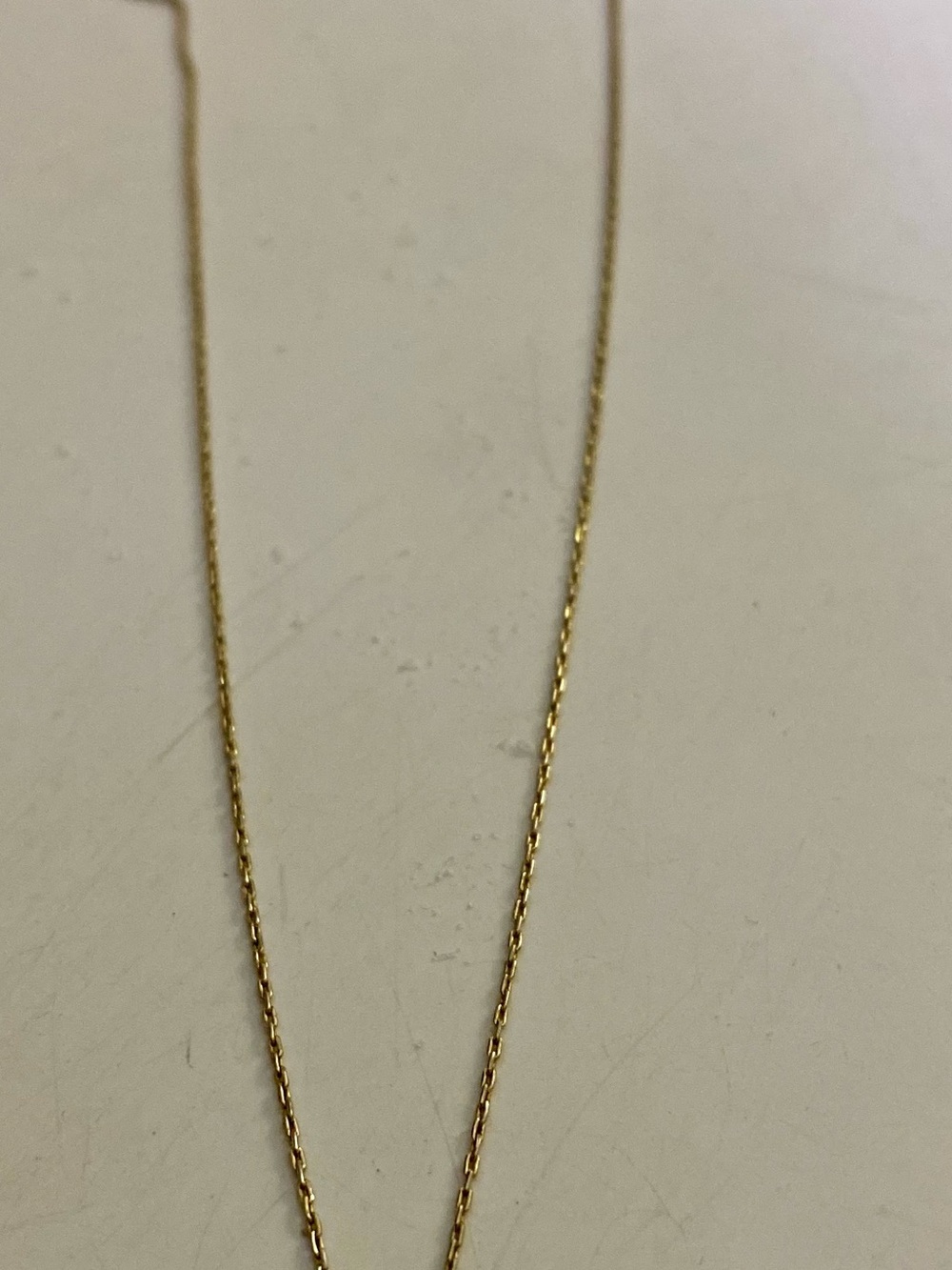 Gold necklace letter E